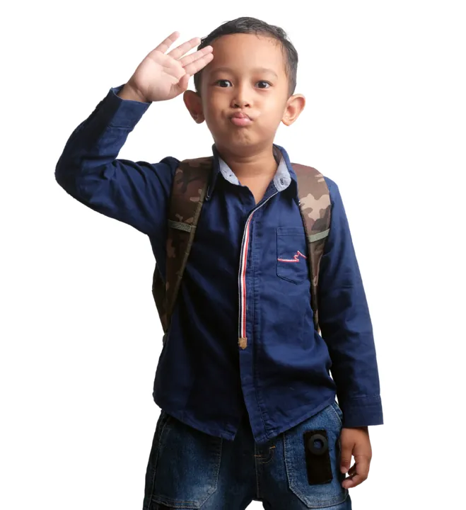 A smiling boy wearing a backpack, saluting